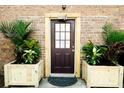 Inviting front entrance with brown door, decorative planters, and brick facade at 1125 Rifle Range Rd, Mount Pleasant, SC 29464