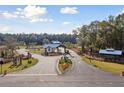 Scenic entrance to a planned community with lush landscaping, decorative signage and community building at 1146 Darling St, Summerville, SC 29485
