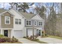 This two-story home includes a garage, manicured landscaping, and a welcoming entrance at 127 Rosefield Ct, Summerville, SC 29485