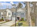 Two-story home featuring a garage, manicured landscaping, and an inviting front entrance at 127 Rosefield Ct, Summerville, SC 29485