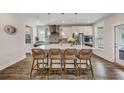 Bright, modern kitchen with a large island, pendant lighting, stainless steel appliances, and wicker chairs at 130 Wappoo Trace Ln, Summerville, SC 29486