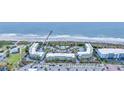 Stunning aerial view of beachside condos with a central pool, directly on the ocean with private beach access at 1300 Ocean Blvd # 114 A, Isle of Palms, SC 29451