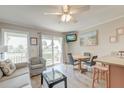 Cozy living room featuring a dining area, comfortable seating, and a sliding glass door to a private balcony at 1300 Ocean Blvd # 114 A, Isle of Palms, SC 29451