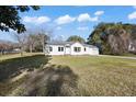 Beautiful single-story house with white siding, a well-manicured lawn, and an attached garage on a sunny day at 1409 Main St, Bonneau, SC 29431