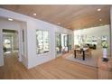 Inviting dining area featuring wood floors, patio access, modern light fixture, and abundant natural light at 1495 Pocahontas St, Mount Pleasant, SC 29464