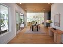 Open-concept dining room with wood floors, slider doors, modern light fixture, and elegant decor at 1495 Pocahontas St, Mount Pleasant, SC 29464