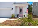 Inviting front entrance with a charming pink door, American flag, and well-kept landscaping at 162 Cherry Grv Dr, Summerville, SC 29483