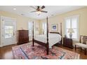 Sunny bedroom with a four-poster bed, hardwood floors, and access to a balcony at 1676 Paradise Lake Dr, Mount Pleasant, SC 29464