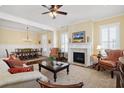 Inviting living room featuring a fireplace, elegant furniture, and a view into the dining room at 1676 Paradise Lake Dr, Mount Pleasant, SC 29464