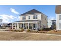 Beautiful home with a wide front porch and a well-maintained lawn at 201 Symphony Ave, Summerville, SC 29486