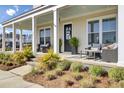 Relaxing front porch with seating area and decorative plants, perfect for outdoor enjoyment at 201 Symphony Ave, Summerville, SC 29486