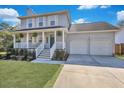 Lovely two-story home with a spacious two-car garage, inviting front porch, and meticulously maintained landscaping at 2029 Country Manor Dr, Mount Pleasant, SC 29466