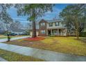Inviting two-story home with attached garage, beautiful yard, and long driveway at 211 Trestlewood Dr, Summerville, SC 29486