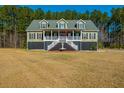 Charming two-story home with welcoming front porch and a manicured front yard, perfect for curb appeal at 214 Shelby Shea Ln, Moncks Corner, SC 29461