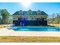 Backyard view with an in-ground swimming pool and patio, perfect for outdoor enjoyment at 214 Shelby Shea Ln, Moncks Corner, SC 29461