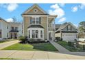 Charming two-story home featuring a landscaped yard, bay window and second story balcony at 2333 Town Woods Rd, Charleston, SC 29414