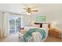Bright main bedroom with ceiling fan, balcony access, and decorative beach accents at 236 Driftwood Ln, Edisto Island, SC 29438