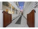 Private driveway with wooden gate and lush landscaping at 34 Percy St, Charleston, SC 29403