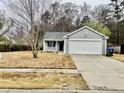 Charming single Gathering home featuring a well-maintained front yard and attached two car garage at 344 Eagle Ridge Rd, Summerville, SC 29485