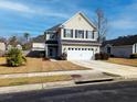 Charming two-story home featuring a two-car garage, landscaped yard, and classic architectural details at 3614 Haymont Ln, Ladson, SC 29456