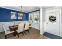 Inviting dining room with stylish lighting, a wooden table, and serene blue accent wall at 414 Hamlet Cir, Goose Creek, SC 29445