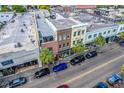 An aerial shot of downtown buildings and a street lined with palm trees and parked cars at 487 King St # 201, Charleston, SC 29403
