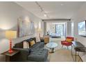 Open living room showcasing a comfortable gray sectional couch, with an adjoined bedroom at 487 King St # 201, Charleston, SC 29403