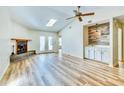 Spacious living room with a cozy fireplace, vaulted ceilings, wood floors, and a stylish built-in bar area at 501 Hedge Way, Summerville, SC 29486
