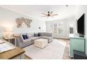Comfortable living room with a large sectional couch, ceiling fan, and stylish decor at 600 Bucksley Ln # 305, Charleston, SC 29492