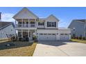 Beautiful two-story home boasts a welcoming porch and a convenient three-car garage at 624 Sienna Way, Summerville, SC 29486