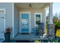 Cozy front porch with rocking chair, stylish decor, and a welcoming entrance at 634 Jancus St, Charleston, SC 29414