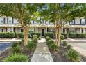 Attractive townhome facade with lush landscaping, inviting entrance, and well-maintained exteriors at 711 Hemingway Cir, Summerville, SC 29483