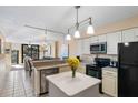 Eat-in kitchen featuring modern appliances, countertops and fixtures, open to the dining and living areas at 7600 Palmetto Drive # D-222, Isle of Palms, SC 29451