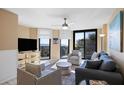 Bright living room with large sliding glass doors accessing the beach-front balcony with ocean views at 7600 Palmetto Drive # D-222, Isle of Palms, SC 29451