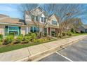 Well-maintained townhome features lush greenery, a manicured lawn, and inviting curb appeal at 7977 Shadow Oak Dr, North Charleston, SC 29406