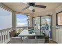 Inviting screened porch with a dining table and stunning ocean view at 9000 Palmetto Dr # G-302, Isle of Palms, SC 29451