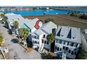 Coastal home with a gray roof near marshland and a bridge with water views at 94 W 2Nd St, Folly Beach, SC 29439