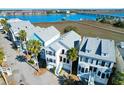 Coastal home with a gray roof near marshland and a bridge with water views at 94 W 2Nd St, Folly Beach, SC 29439