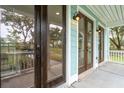 Close-up of a front porch with wooden and glass doors and modern light fixtures at 126 Cantona Dr, Summerville, SC 29483