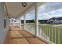 Inviting porch with wood floors and bright lighting, perfect for relaxing and enjoying the outdoors at 1329 Wood Sorrel Dr, Moncks Corner, SC 29461