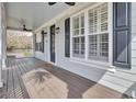 Inviting covered front porch featuring a stained wood floor and ceiling fans at 1357 Osmond Rd, Mount Pleasant, SC 29466