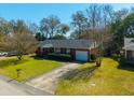 Aerial shot of a well-kept brick home boasting a driveway and a lush green lawn at 1423 Fairfield Ave, Charleston, SC 29407