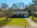 Birds-eye view of a brick home with mature trees, a green lawn, and a paved driveway at 1423 Fairfield Ave, Charleston, SC 29407