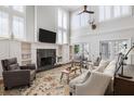 Bright living room with a soaring ceiling, fireplace, built-in shelves, and plenty of natural light at 1464 Dupree Creek Rd, Awendaw, SC 29429