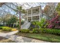 Stunning two-story home featuring double porches, mature trees, and a picturesque sidewalk at 1543 Wando Landing St, Charleston, SC 29492