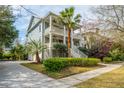 Beautiful two-story home with double porches, mature landscaping, and a welcoming driveway at 1543 Wando Landing St, Charleston, SC 29492