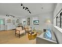Bright living room with modern lighting, decor, and an open floor plan to the dining area at 1563 Traywick Ave, Johns Island, SC 29455
