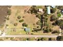 Aerial view of a spacious property with a pond, sheds, and a well-maintained lawn at 16 Baldwin Ln, Green Pond, SC 29446