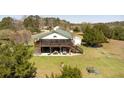 Exterior elevation of a stilted house with a spacious screened porch and well-maintained lawn at 16 Baldwin Ln, Green Pond, SC 29446