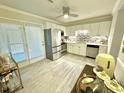 Well lit kitchen featuring stainless steel appliances, white cabinetry, and tiled backsplash at 1713 Boone Hall Dr # I9, Charleston, SC 29407